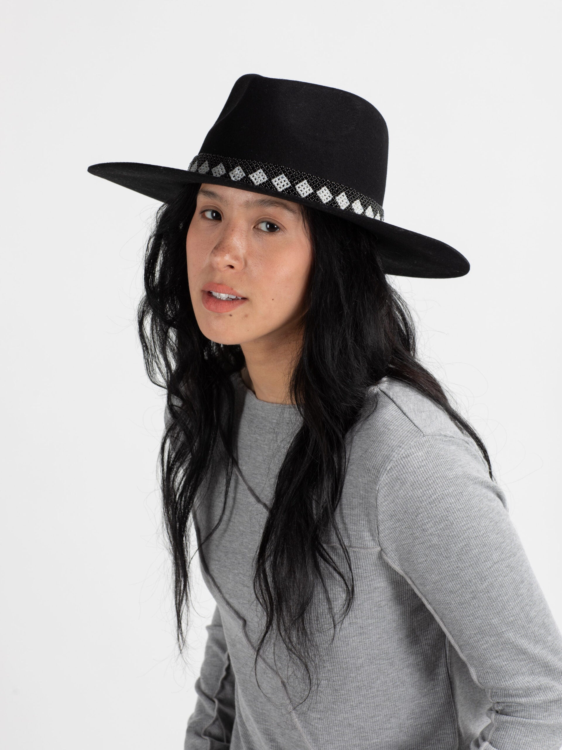 Woman wearing black Cairo handmade fedora hat with beaded band