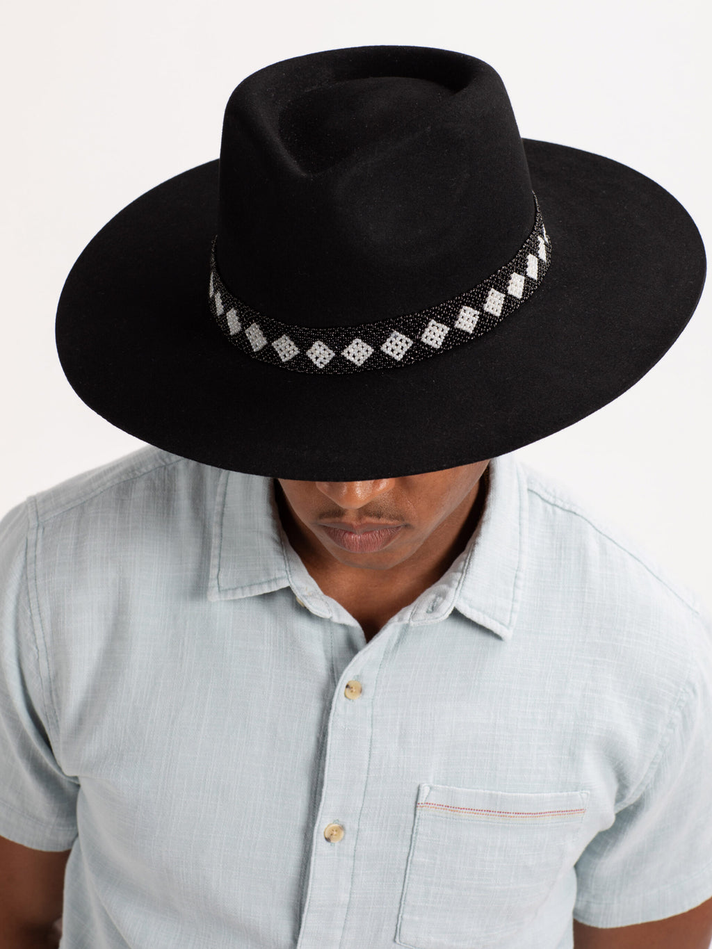 Man wearing black Cairo fedora hat, top view showing Rwandan beadwork