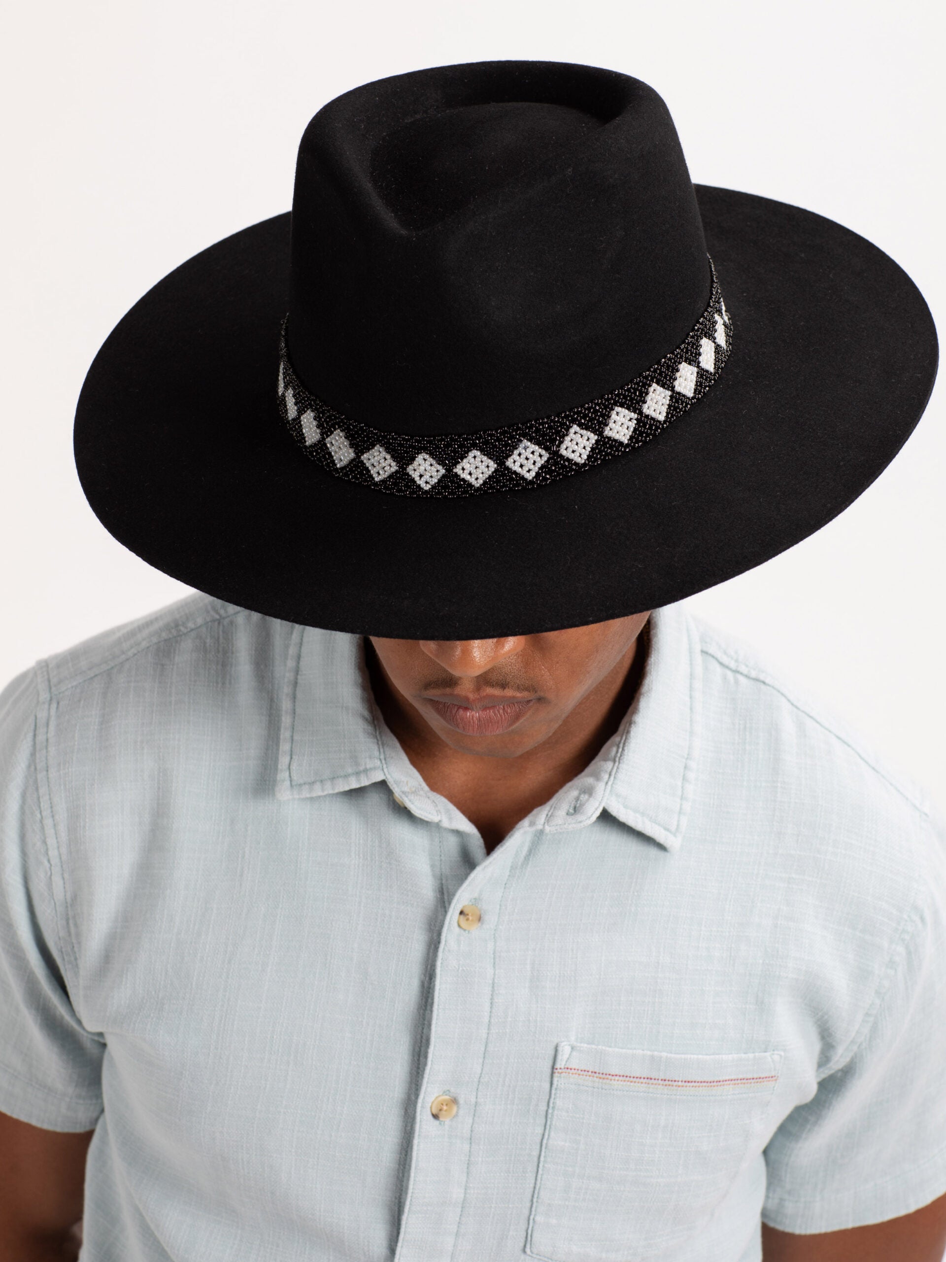 Man wearing black Cairo fedora hat, top view showing Rwandan beadwork