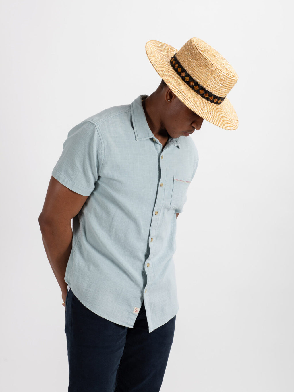 Man wearing Kingston straw fedora hat with Rwandan beadwork
