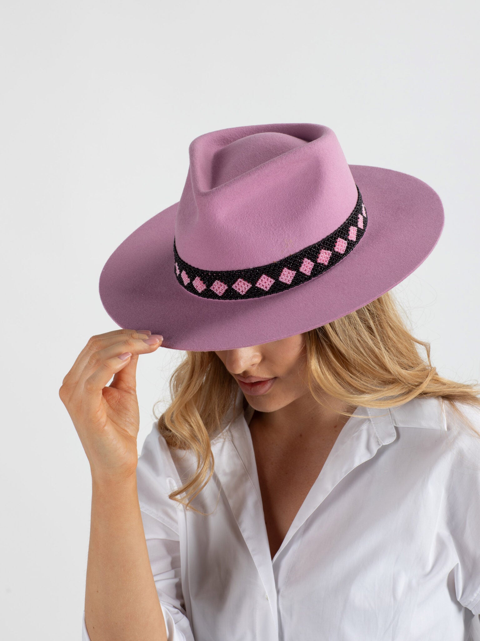 Woman wearing soft pink Paris handmade fedora hat