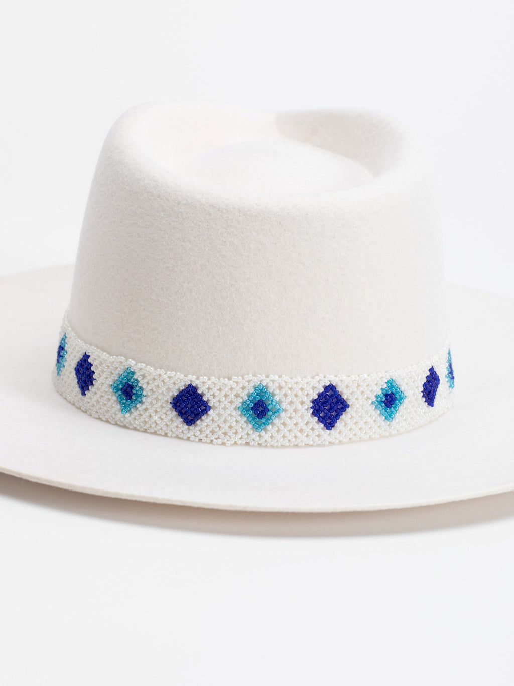 Close-up of Rwandan beaded band on Santorini white fedora crown