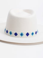 Close-up of Rwandan beaded band on Santorini white fedora crown