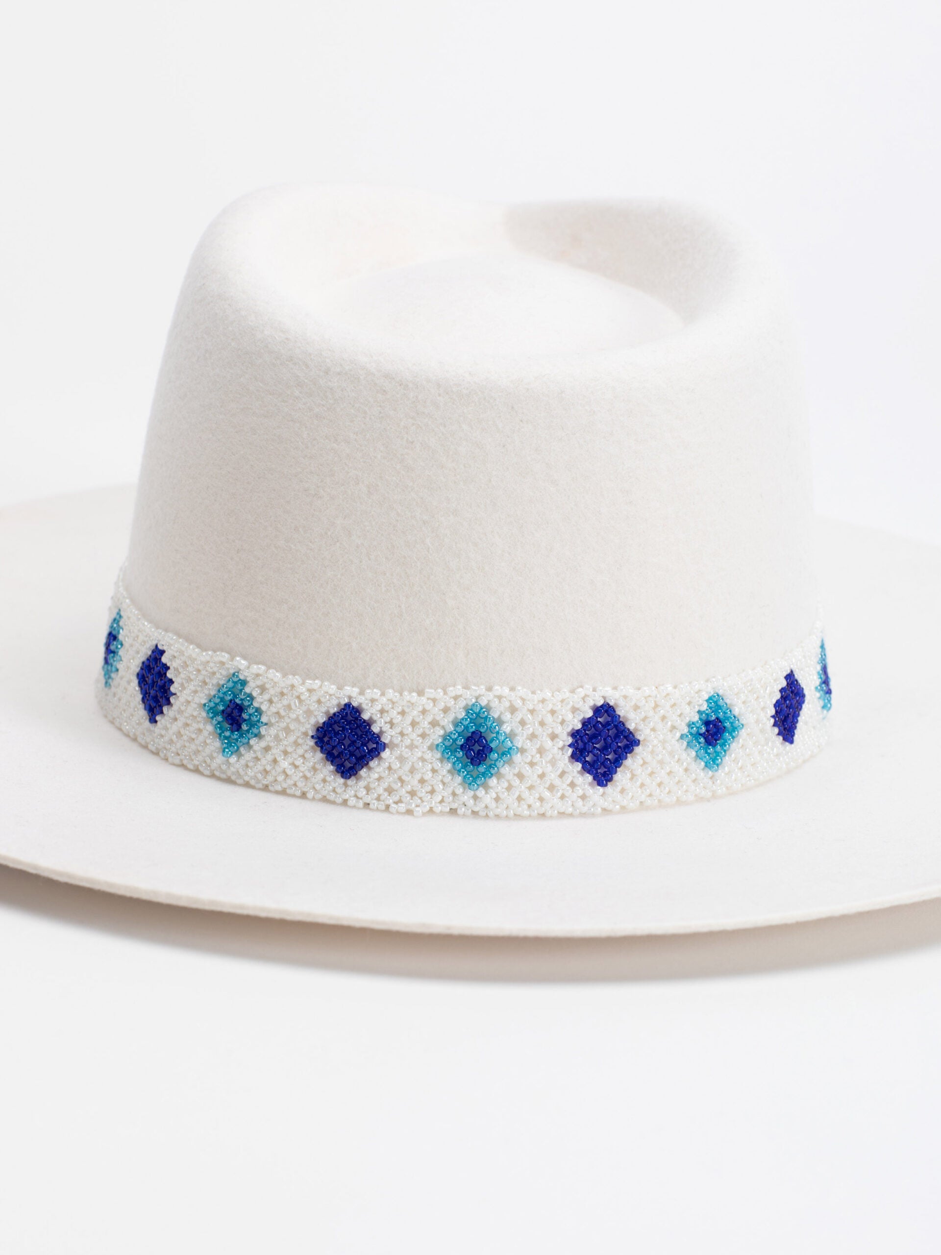 Close-up of Rwandan beaded band on Santorini white fedora crown