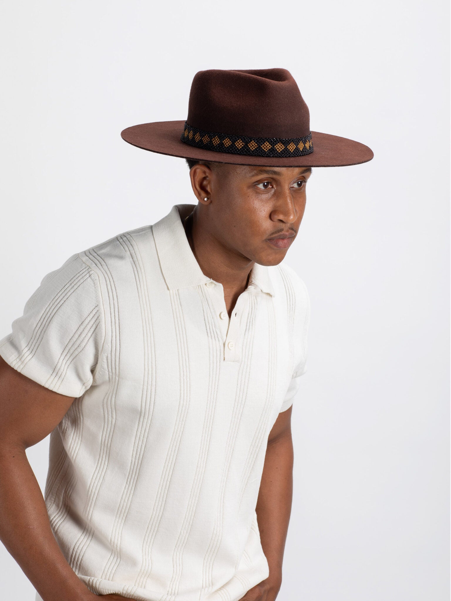 Man wearing brown Tahoe fedora hat showing Rwandan beadwork