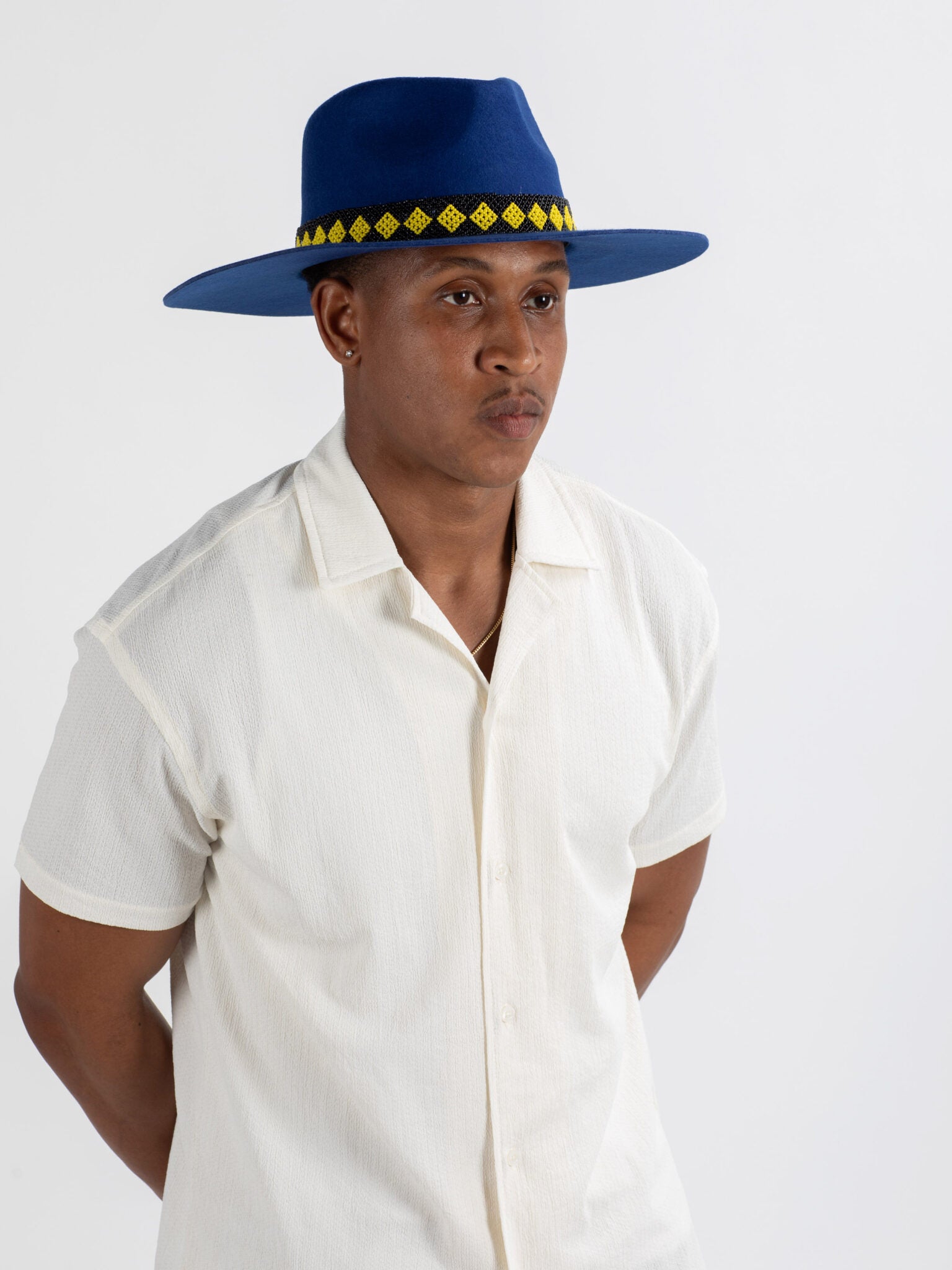 Man wearing The City fedora hat showing Rwandan beadwork